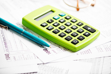 Naklejka na ściany i meble Tax form, pen and calculator
