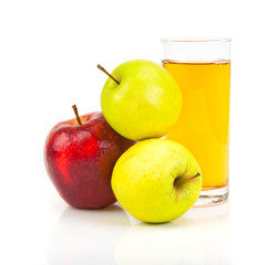 Delicious apple juice in glass and apples isolated on white
