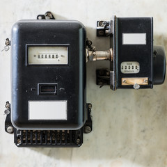 old black plumbed power meter at wall