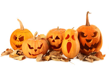 Halloween pumpkins with dry leafs isolated on a white