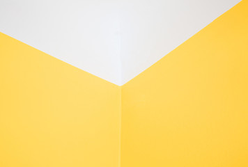 Corner yellow wall and white ceiling.Horizontal view.