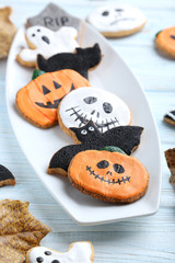 Fresh halloween gingerbread cookies on blue wooden table