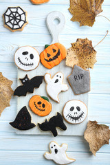 Fresh halloween gingerbread cookies on blue wooden table