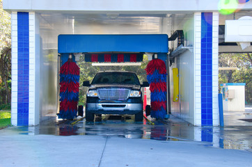 An automated car wash facility with a soapy truck in the process of getting washed © Michael O'Keene