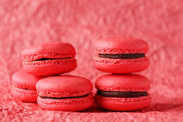 Red macarons on red paper background