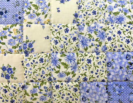 close up of an old-fashioned blue floral patchwork quilt 