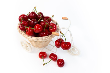 Obraz na płótnie Canvas Cherries in decorative basket on a bicycle, isolated
