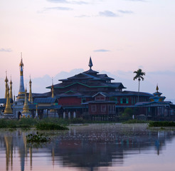 Fototapeta na wymiar Ancient pagoda and monastery at sunrise on Inle lake, Myanmar