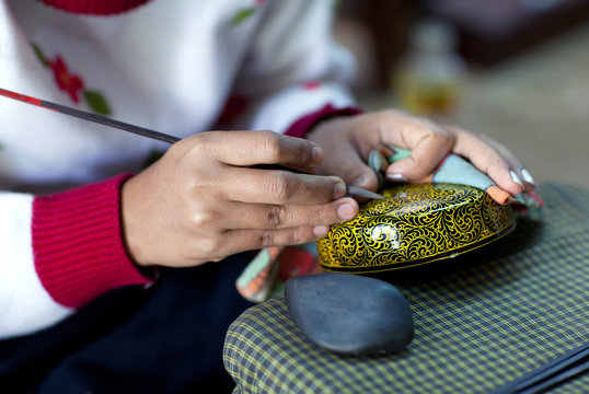Burmese woman working in a factory of lacquer