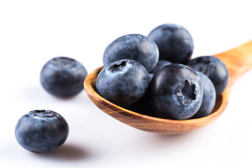 Fresh blueberries in wooden spoon