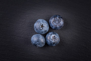Blueberries on stone plate background