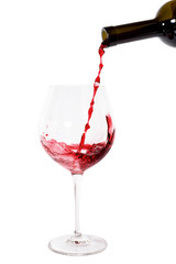 Fototapeta na wymiar Red wine pouring into wine glass