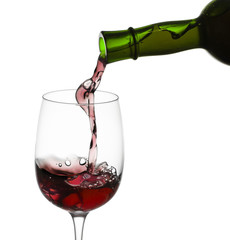 red wine pouring in glass from a bottle isolated on white backgr