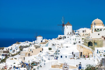 Sky, sea near traditional white village in Santorini