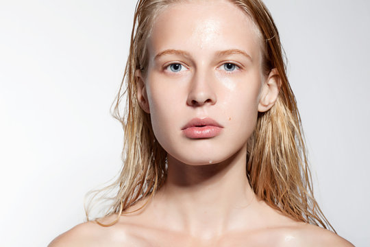 Portrait of a young woman with clean shiny skin and full lips with natural beauty
