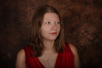 Fototapeta premium Portrait of young woman on brown batik background