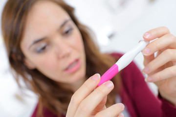 Holding a pregnancy tester