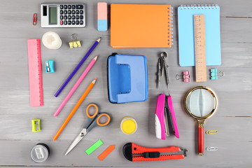 Bright stationery objects on wooden table close up