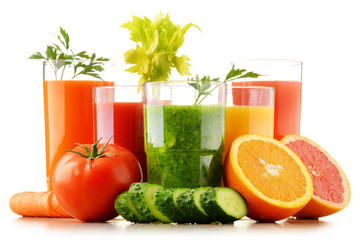 Glasses with fresh organic vegetable and fruit juices on white