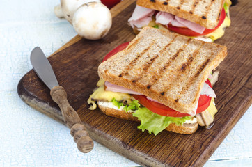 Tasty healthy sandwiches at white wooden table. Rustic style. Shallow focus