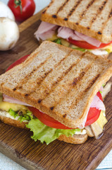 Tasty healthy sandwiches at white wooden table. Rustic style.