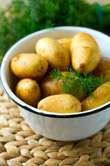raw baby potatoes on wooden surface