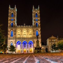 Fototapeta na wymiar Montreal Notre Dame Basilica illuminated at night with stone texture