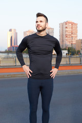 Fototapeta premium Muscular build handsome athlete resting after a morning run stan