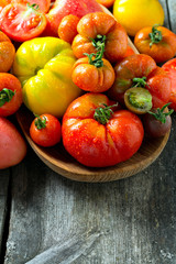 assorted tomatoes on wooden surface