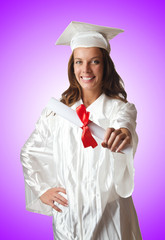 Young student with diploma on white
