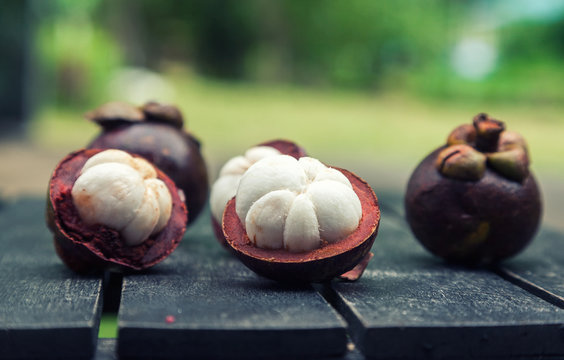 mangosteens on a wooden table