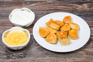 Fried dumplings, sour cream and cheese sauce