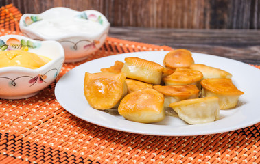 Fried dumplings, sour cream and cheese sauce