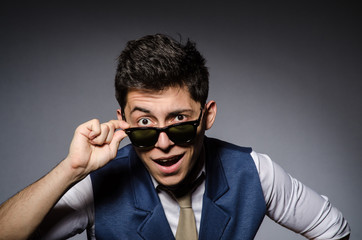 Fototapeta premium Young man in blue vest against gray