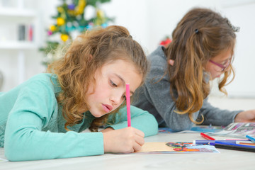 Two young girls drawing