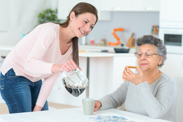 Pouring a coffee for her grandma