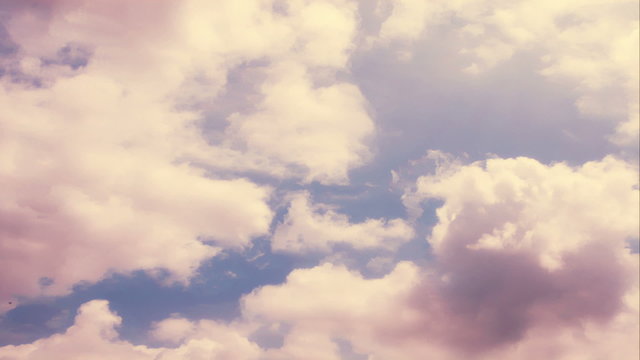 Clouds 1513: Time lapse golden clouds travel across a blue sky.