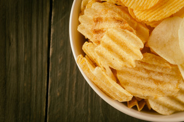 potato chips on wood - soft focus with vintage film filter