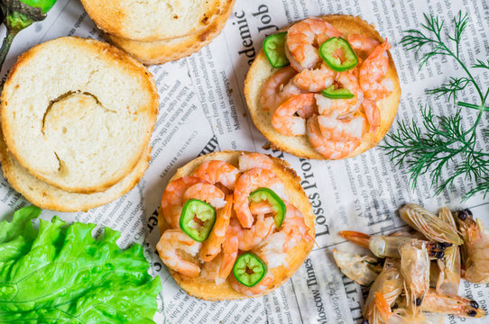 Tapas appetizers with shrimp on paper