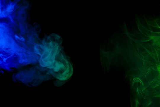 Abstract blue and green smoke hookah on a black background.