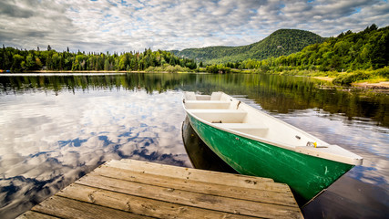 Boat by deck on a lake in National Park Mont Tremblant, Canada. Travel, explore, adventure,...