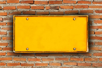 blank license plate on brick wall background