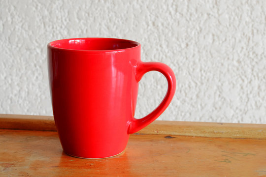 Red Mug On the Side of A Table