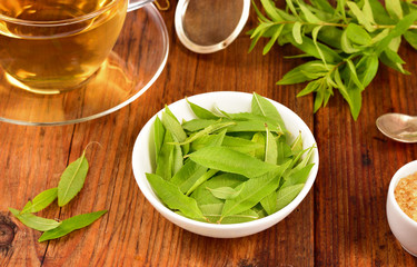 Lemon verbena leaves and tea on table.
