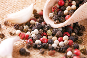 Pepper and garlic in a wooden spoon