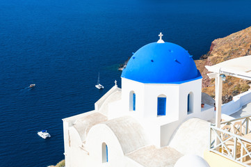 Fototapeta na wymiar Church with blue domes in Oia town, Santorini island, Greece