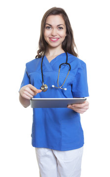 Moderne Krankenschwester mit dunklen Haaren und Tablet