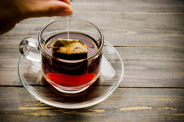 Hot tea on wooden background in the morning