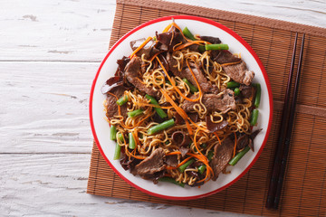 Chinese noodles with beef, muer and vegetables. Horizontal top view   © FomaA