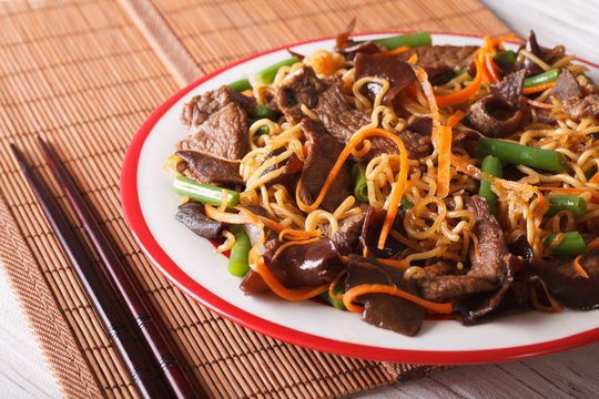 Lo mein with beef, muer and vegetables close-up. horizontal
